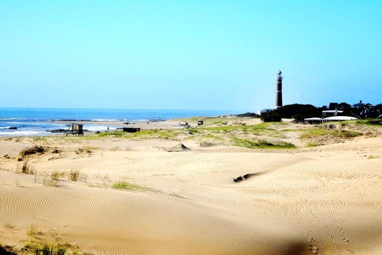 Lanscape of an isolated beach in Jose Ignacio, Uruguay with a lighthouse in the distance