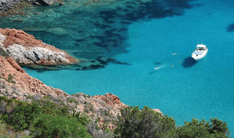 Aerial view of privately chartered yacht in blue sea during luxury Corsica trip