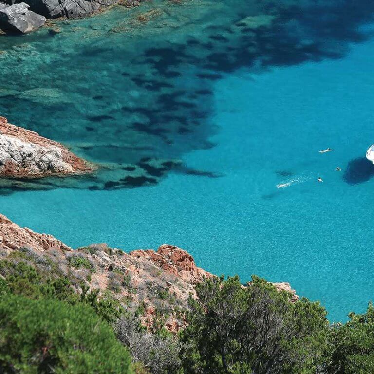 Aerial view of privately chartered yacht in blue sea during luxury Corsica trip