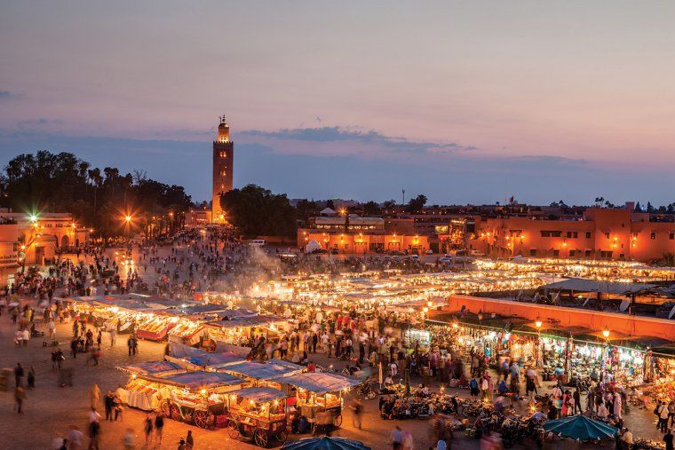 Aerial view of the activity in Marrakesh's Jemaa-el-Fna square, lit up in the evening