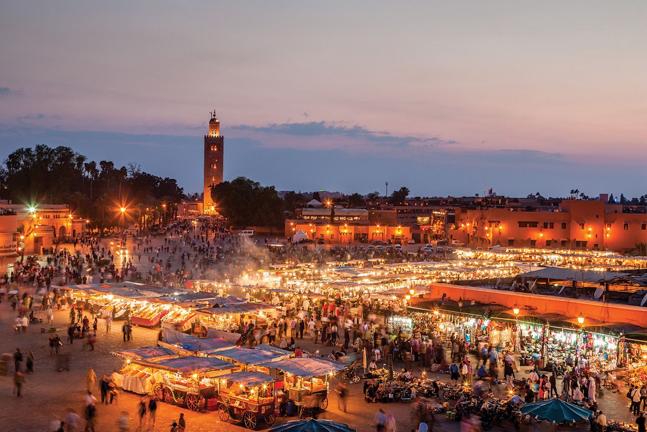 Aerial view of the activity in Marrakesh's Jemaa-el-Fna square, lit up in the evening