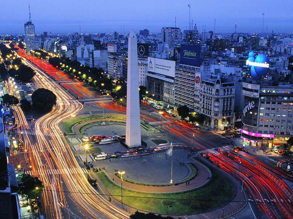 Aerial timelapse shot of traffic around the Obelisk in Avenida 9 de Julio just after sunset in Buenos Aires