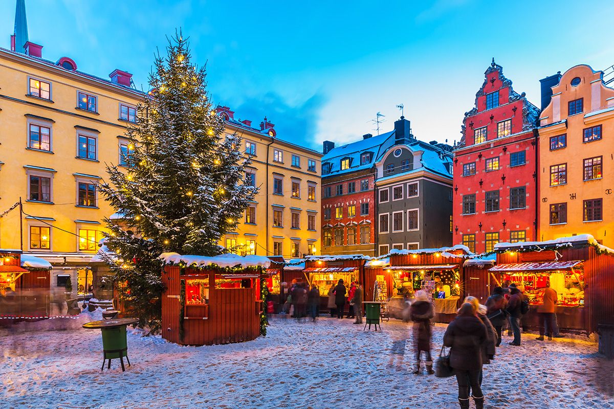 People visiting vendors in snowy Grand Square in Stockholm's old town