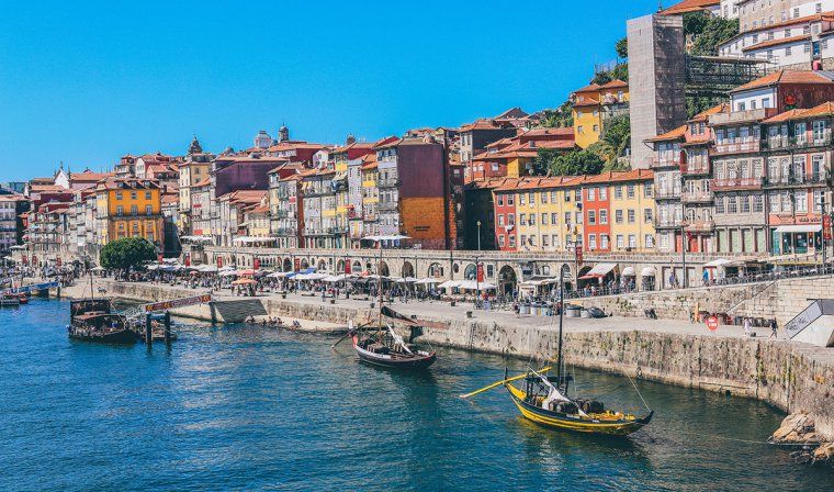 Boats and colorful buildings along the river in Porto, Portugal