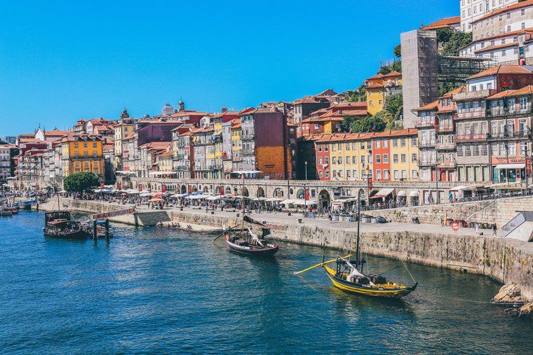 Boats and colorful buildings along the river in Porto, Portugal