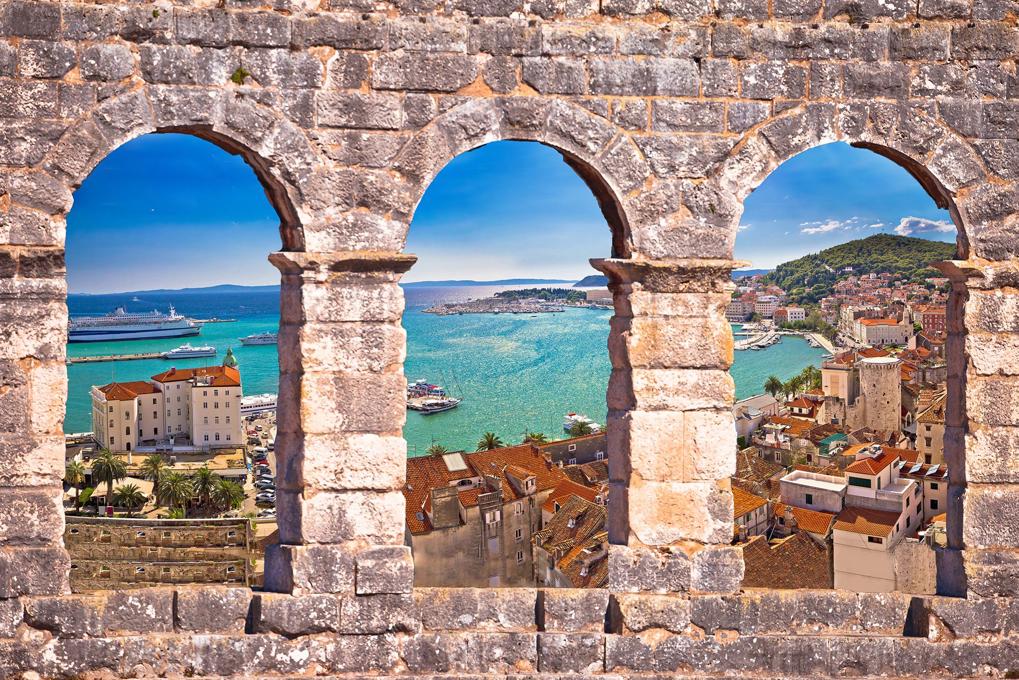 Split waterfront through stone arch windows during luxury Croatia tour