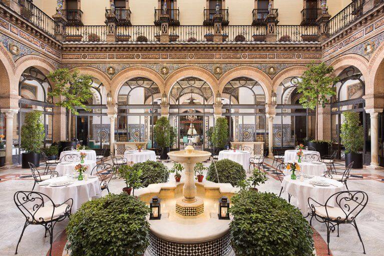Courtyard of Alfonso XIII hotel with decorative painted tiles and arches