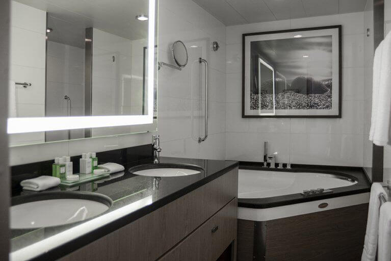 Interior view of a bathroom aboard the Austral, with two sinks and a spacious bathtub