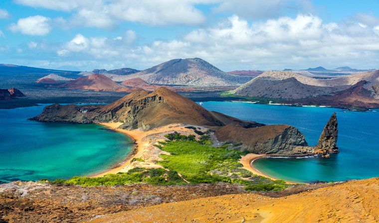 Rocky peninsula with sandy beaches on Bartolome Island in Galapagos archipelago