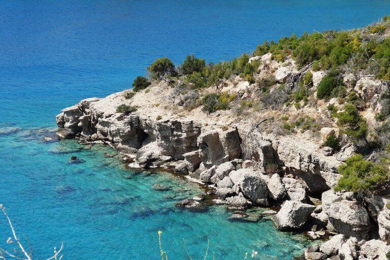 Rocky beach and crystal clear water on the coast of Peloponnese peninsula