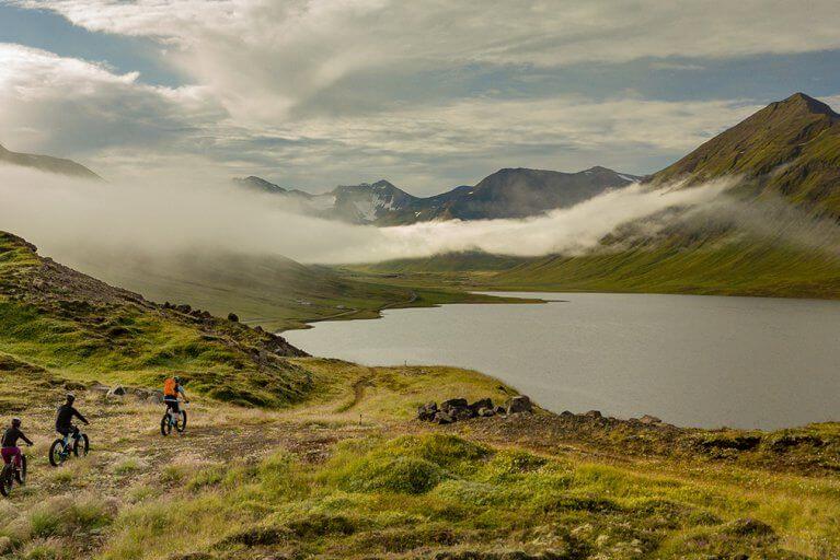 Biking excursion in the steppe, with low clouds covering the mountains