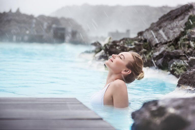 Woman enjoying a soak in the thermal baths of Iceland's Blue Lagoon