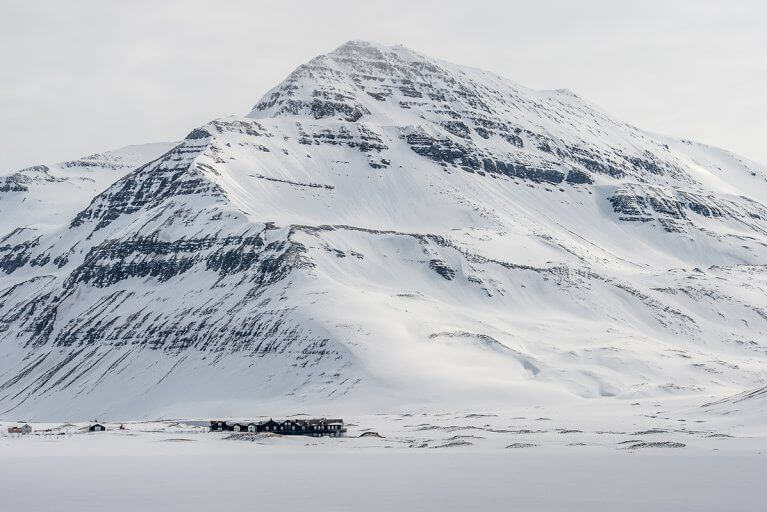 Buildings of Deplar Farm Luxury Hotel looking small againt a snow covered mountain