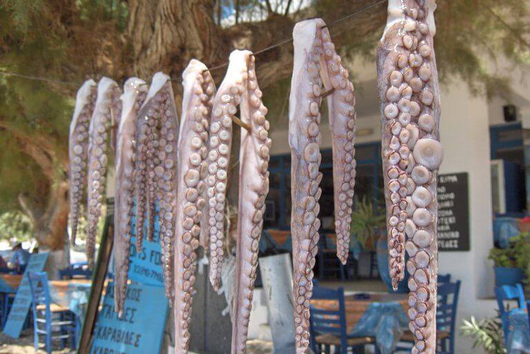 Octopus tentacles hanging outside of restaurant on Sifnos Island in Greece