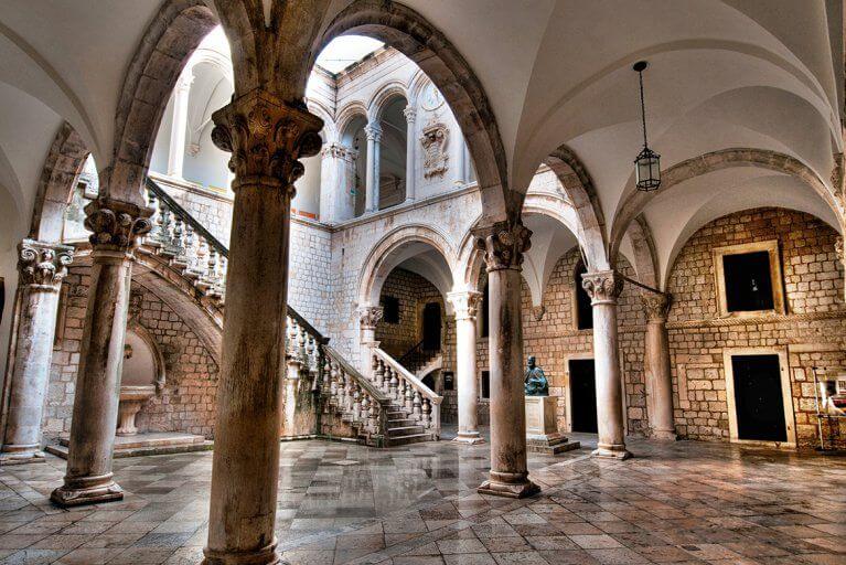 Interior of historic stone building with columns and arches in Dubrovnik, Croatia