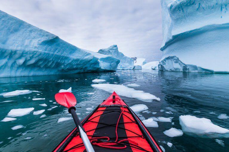 Kayaking excursion among the impressive icebergs of Antarctica during a luxury cruise