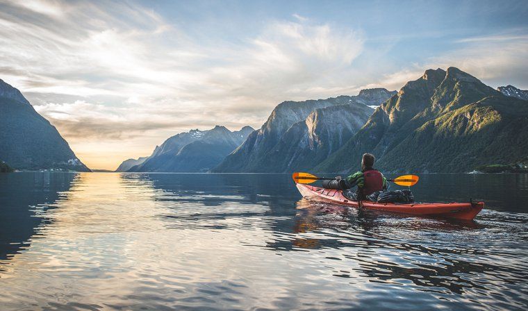 Kayaking excursion in Hjørundfjord Fjord during summer in Norway