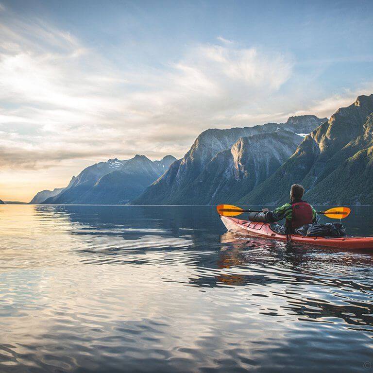 Kayaking excursion in Hjørundfjord Fjord during summer in Norway