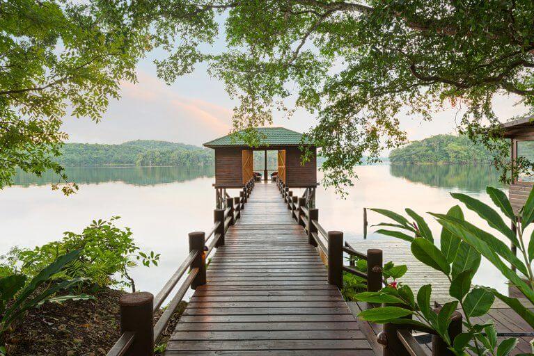 Dock leading to a boathouse at Las Lagunas Boutique Hotel, a luxury property in Peten, Guatemala