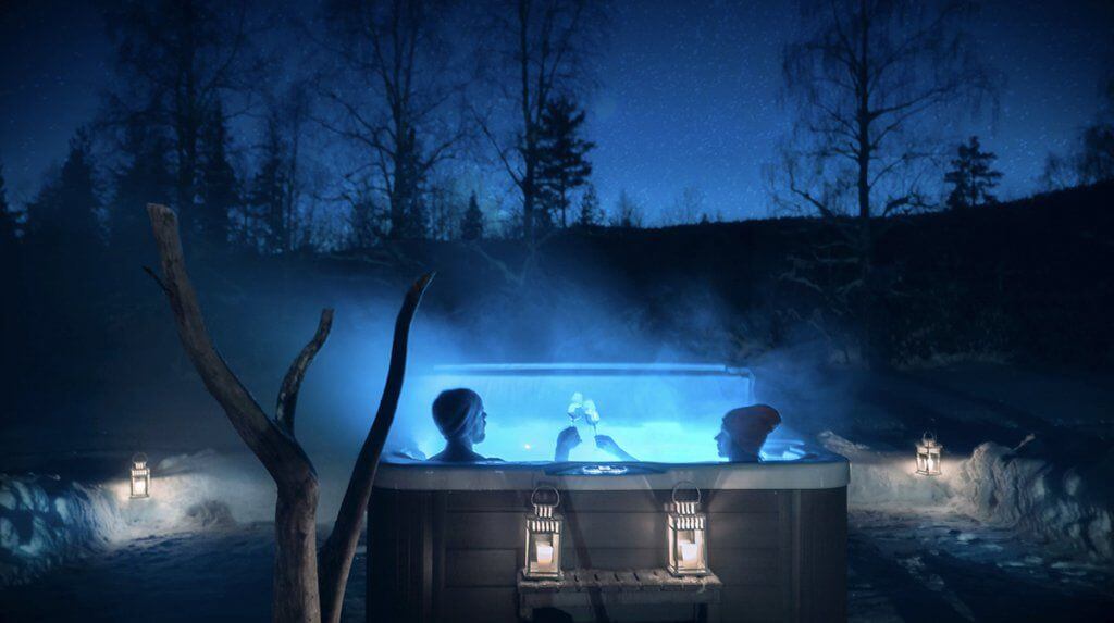 Champagne toast in an outdoor jacuzzi at night