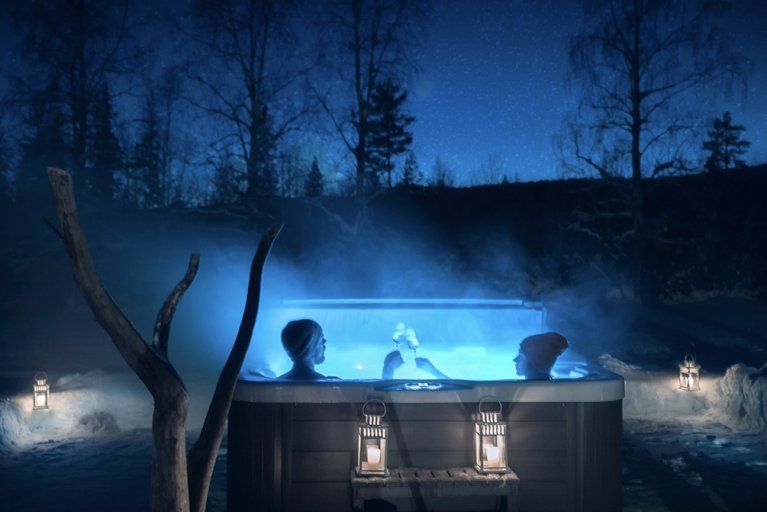 Champagne toast in an outdoor jacuzzi at night