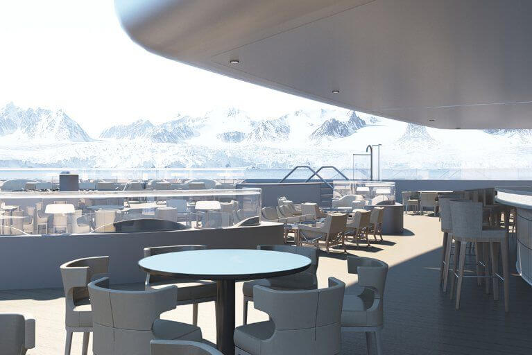 Outdoor lounge on the stern of a luxury cruiseship, with the snowy peaks of Antarctica visible in the background