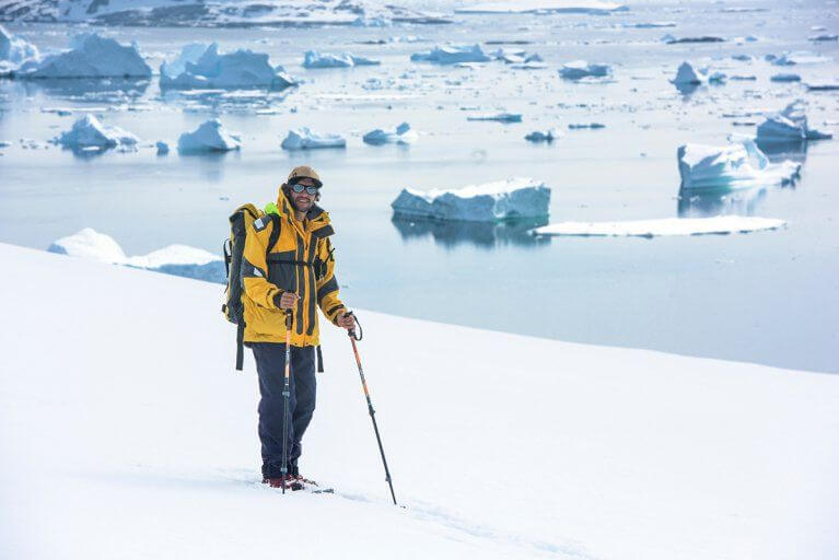 Man Snowshoeing Icebergs Antarctica