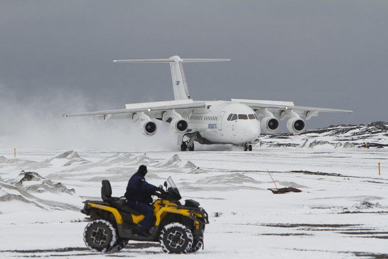 Man Watching Plane Landing Antarctica