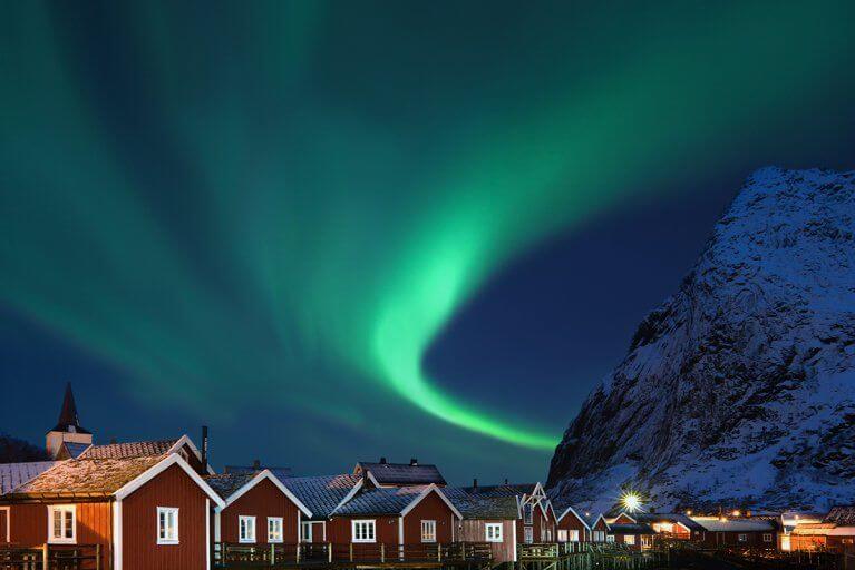 Northern lights above a fishing village in Lofoten, Norway