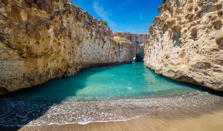 Turquoise water and rocky cliffs at Papafragas Beach on Milos island in Greece