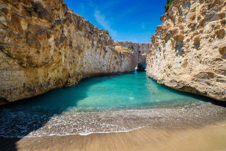 Turquoise water and rocky cliffs at Papafragas Beach on Milos island in Greece