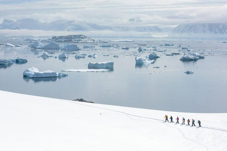 People Snowshoeing Near Ocean Antarctica.