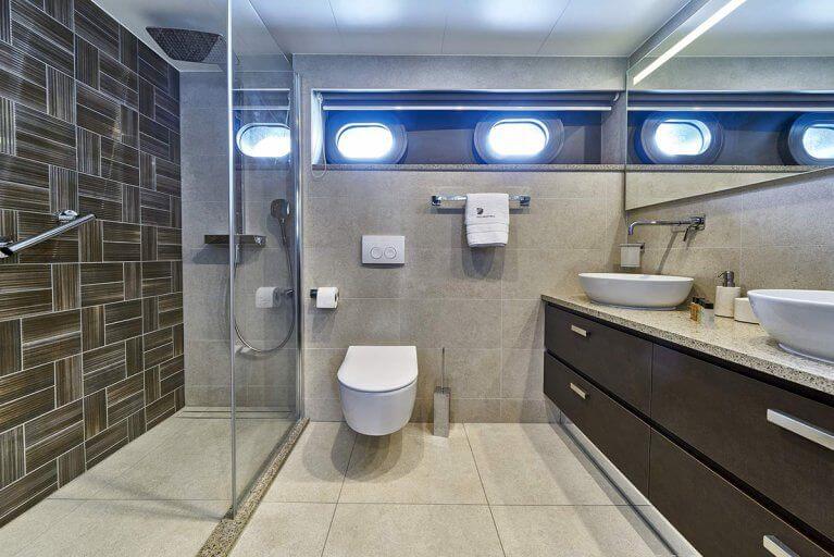 Private bathroom with two sinks on a luxury yacht cruising on the Adriatic sea