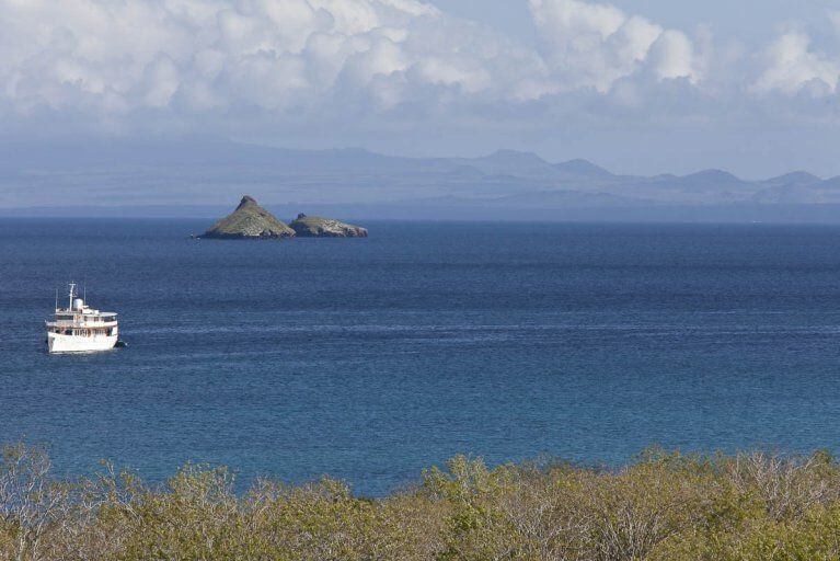 Private luxury yacht sails between islands in the Galapagos archipelago