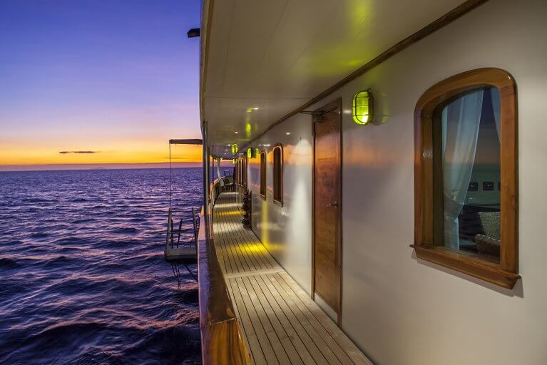 Side deck outside of cabin on a luxury yacht at sunset during Galapagos Islands cruise