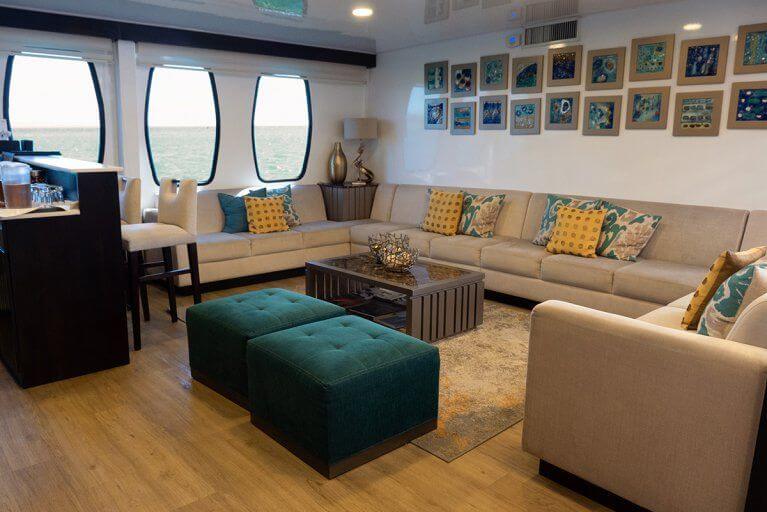 Large sofa in lounge area of private luxury yacht cruising in the Galapagos Islands