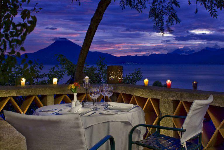 Intimate private dinner set-up with views of Lake Atitlan and volcanoes at sunset