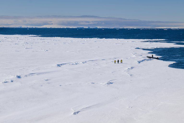 Panoramic photo of a trekking excursion on the vast, snowy expanse of Antarctica during a Weddell Sea luxury cruise