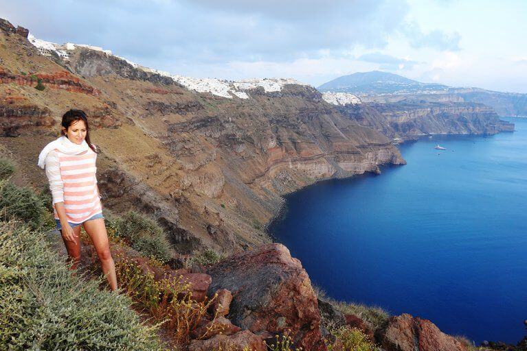 Woman enjoys a private hiking excursion on Skaros Rock in Santorini