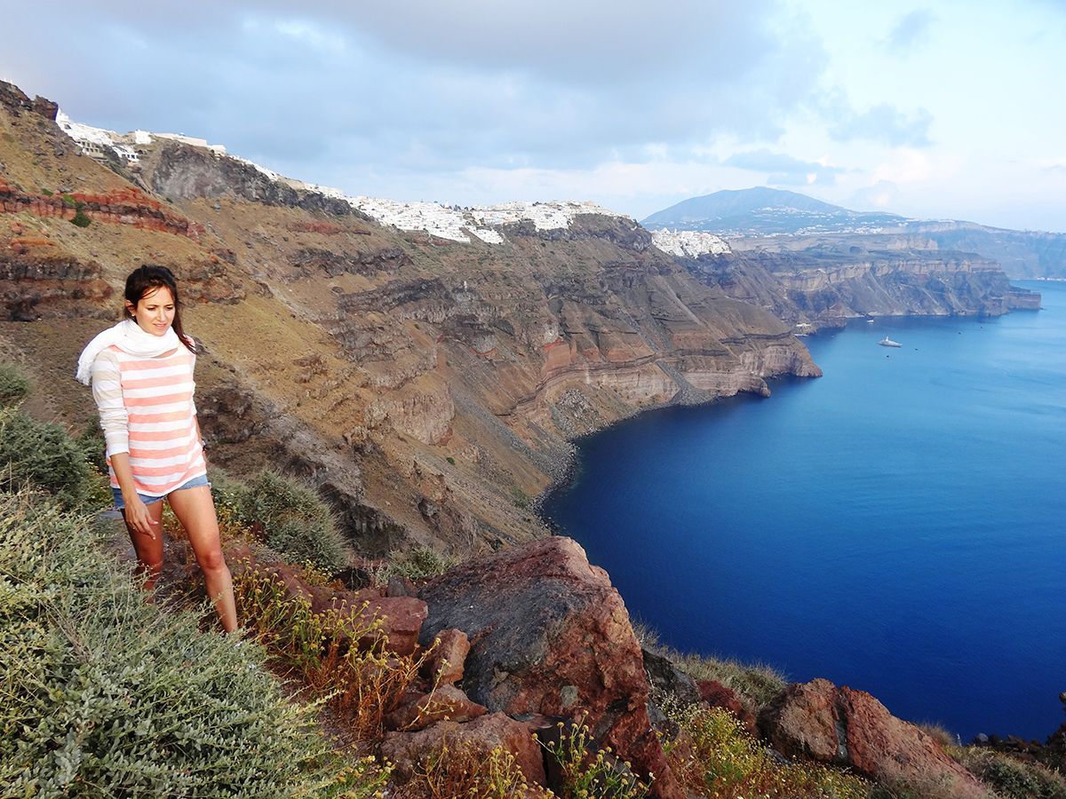 Woman enjoys a private hiking excursion on Skaros Rock in Santorini