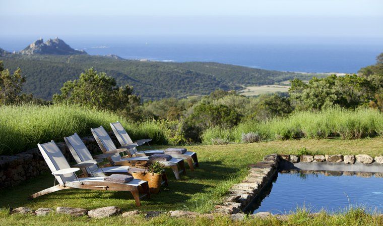 Outdoor pool at Domaine de Murtoli with views of countryside of Corsica