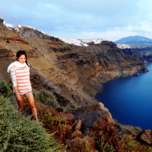 Woman enjoys a private hiking excursion on Skaros Rock in Santorini