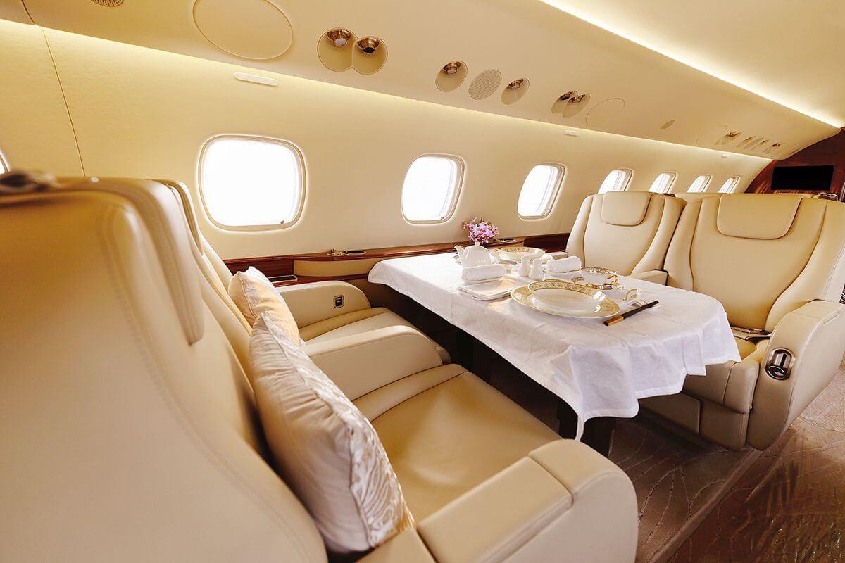 Private jet flies above clouds