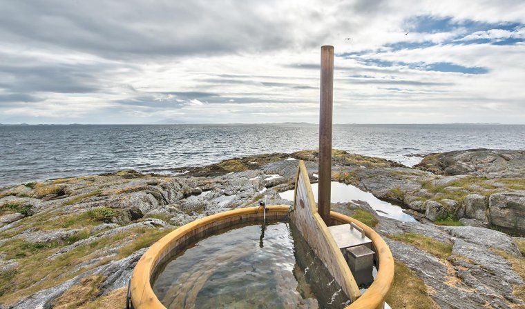 Hot tub perched on a rocky ledge on the Norwegian sea