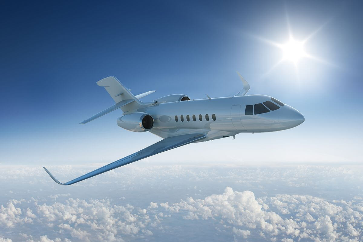 Private jet flies above clouds