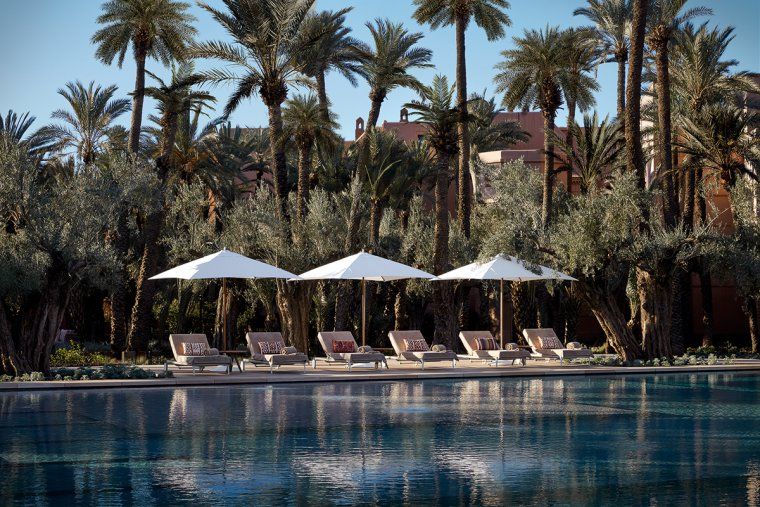 Outdoor pool with palm trees at Royal Mansour hotel in Marrakesh