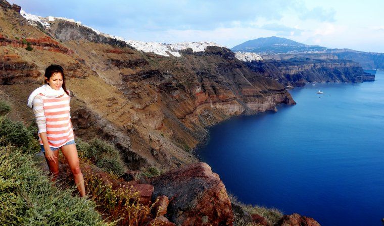 Woman enjoys a private hiking excursion on Skaros Rock in Santorini