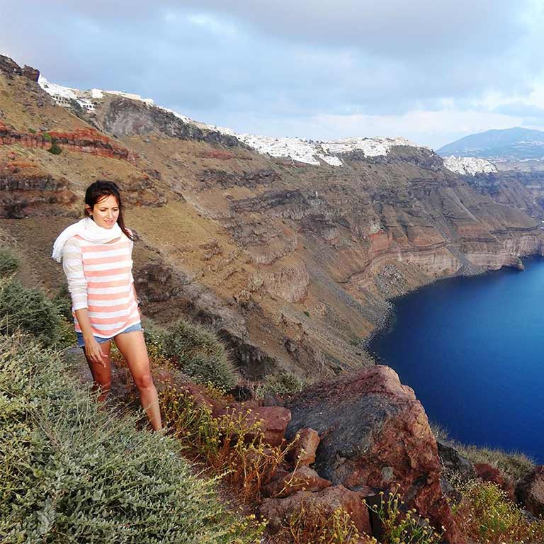 Woman enjoys a private hiking excursion on Skaros Rock in Santorini