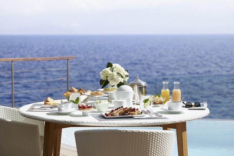 Room service on terrace overlooking Aegean sea at luxury hotel in Greece