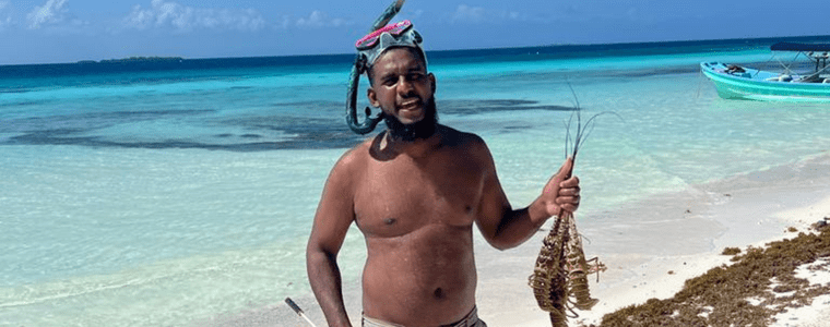 Man catches fish of the day and serves for lunch in Belize